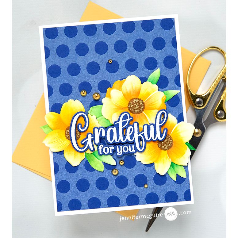 Gina K Designs Dancing Leaves Stamps and Dies blue card with dark blue polka dots as background. yellow flowers with green leaves and the sentiment grateful for you | color-code:alt2