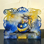AALL & Create Moo-ry Christmas! A6 Clear Stamp Set 1496 cow holding ornament blue and yellow background dream card