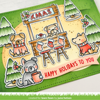 A handmade Christmas-themed card featuring cartoon dogs around a wooden Xmas stall, with red stockings, green trees, and a pink banner reading “HAPPY HOLIDAYS TO YOU.”.