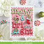A handmade Christmas greeting card with scalloped edges, featuring raised 3D lettering that reads 'merry & bright' on a pink striped background, surrounded by festive embellishments including a stocking, candy cane, and small holiday characters. The card is styled on a white wood surface with white flowers and candy canes around it.