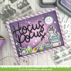 A handmade Halloween-themed card with a purple and lavender background, featuring the words 'Hocus Pocus' in large black script, a white cat dressed as a witch sitting on books, potion bottles, and a speech bubble that says 'YOU'RE SPELLICAL TO ME.'