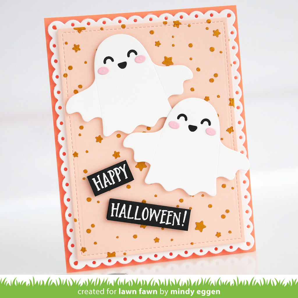 A handmade Halloween greeting card featuring two cute white ghost cutouts with smiling faces, pink cheeks, and gold star confetti on a peach and orange layered card. Two black banner tabs read 'HAPPY HALLOWEEN!'. | color-code:alt1