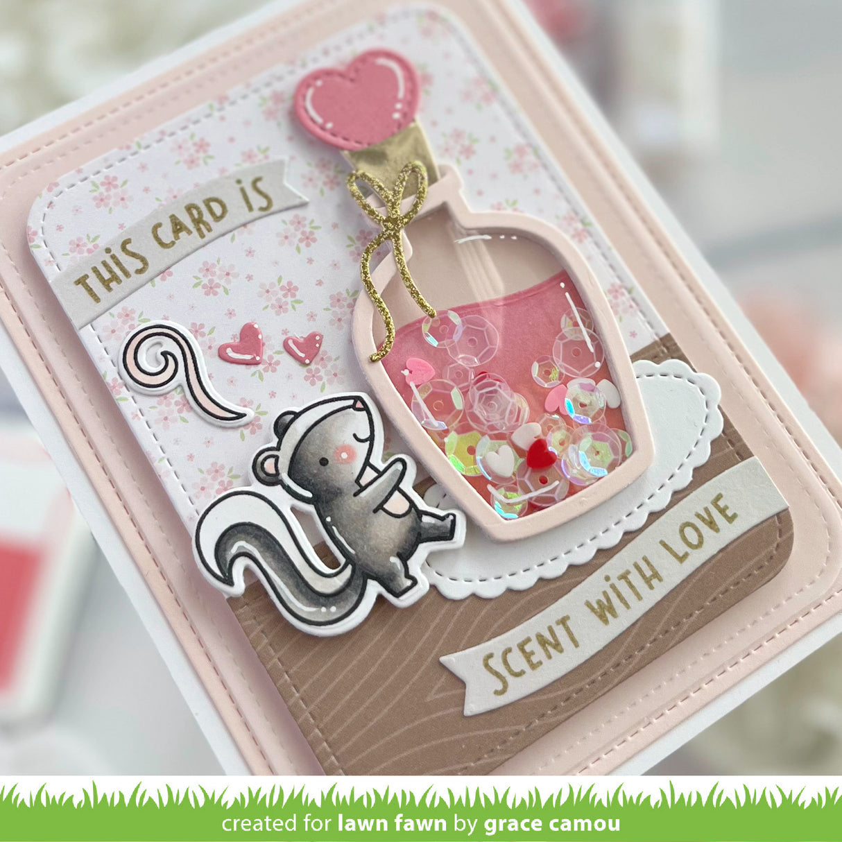 A handmade greeting card featuring a cute cartoon squirrel, a pink shaker bottle filled with sequins and bubbles, and the text 'THIS CARD IS SCENT WITH LOVE'.