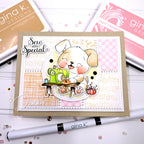 A handmade greeting card featuring a cute puppy sewing with a green sewing machine, styled on a kraft card base with layered white and pink patterned paper. The card is surrounded by Gina K.