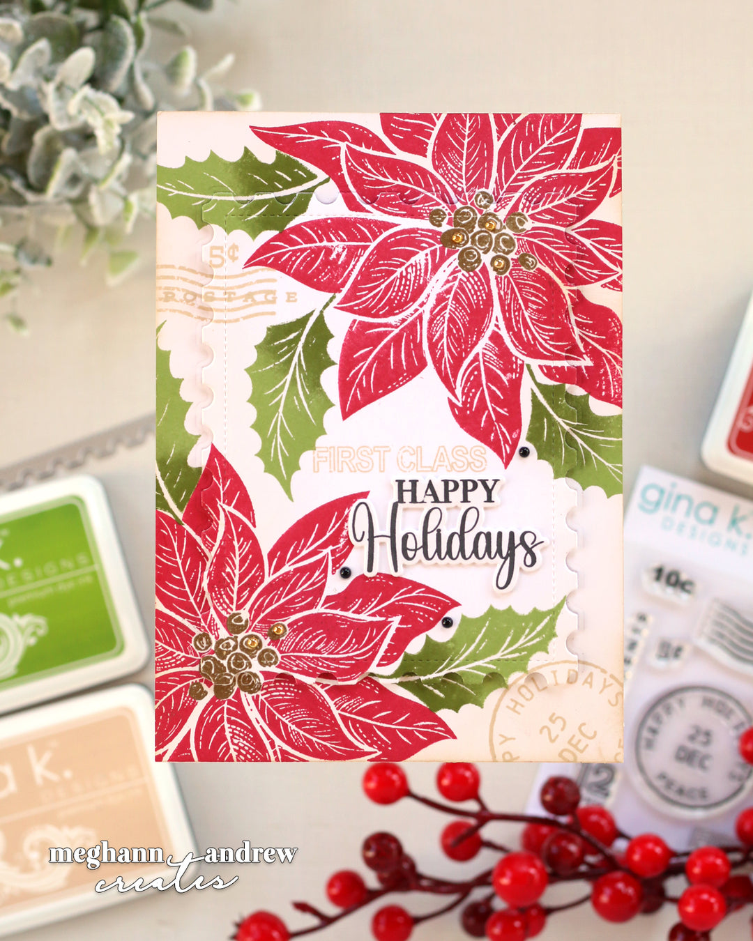 A handmade holiday greeting card featuring red poinsettias, green holly leaves, and 'HAPPY Holidays' text, styled with stamps and red berries on a neutral background.
