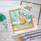 Card with a summer-themed illustration of a woman lounging, surrounded by markers and decorative elements on a wooden surface.