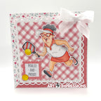 Card with a cartoon character playing paddle ball, featuring Art Impressions branding.