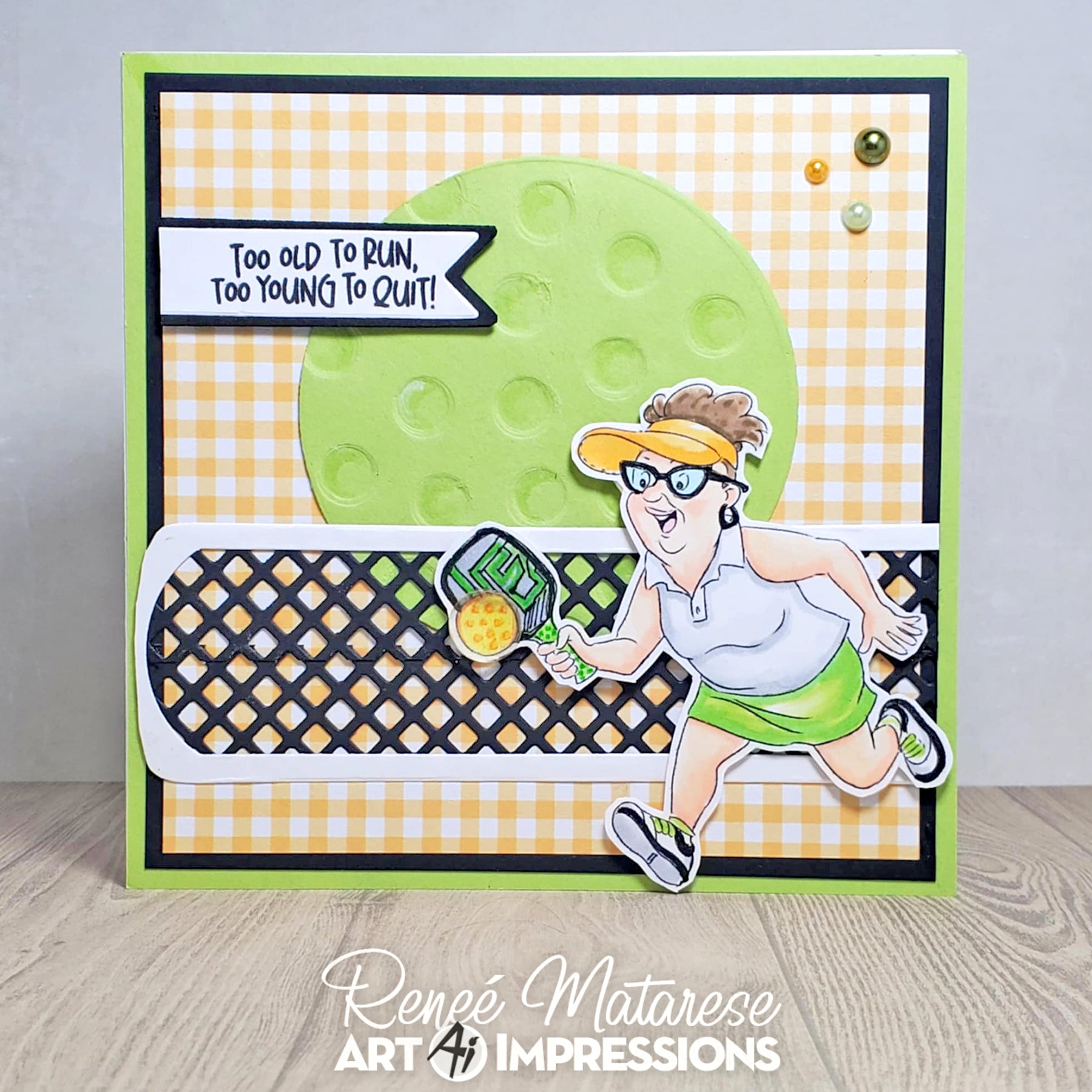 Card with a cartoon character running and holding a tennis racket, with text 'Too old to run, too young to quit!' on a checkered background.