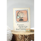 Baby shower card with 'Hello World' and '#congrats #bundle of joy #baby girl #let's celebrate' text on a wooden block.