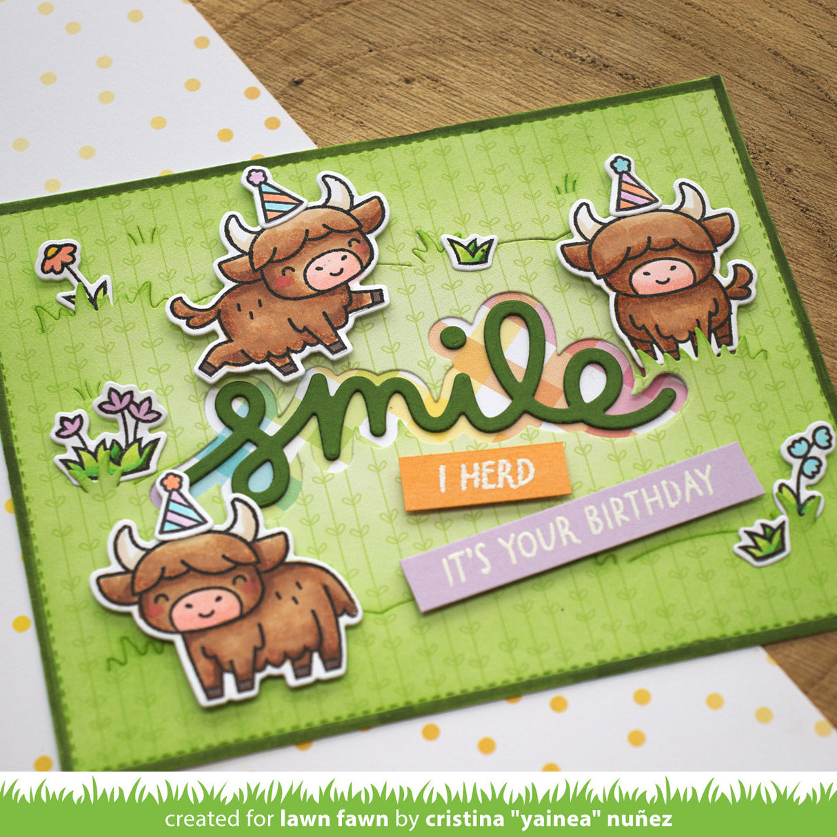 Birthday card with highland cows and 'smile I herd it's your birthday' text on a green background.