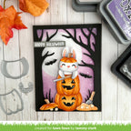 Halloween-themed card with a cat on pumpkins and 'Happy Halloween' text, surrounded by crafting tools.