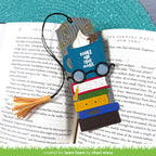 Colorful bookmark with glasses, books, and tassel on an open book | color-code:alt1
