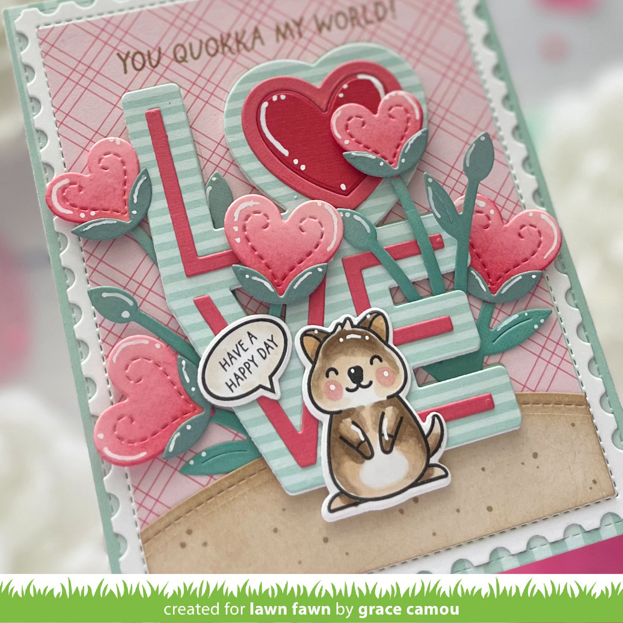 Card with Quokka, hearts, and 'LOVE' text on a pink checkered background