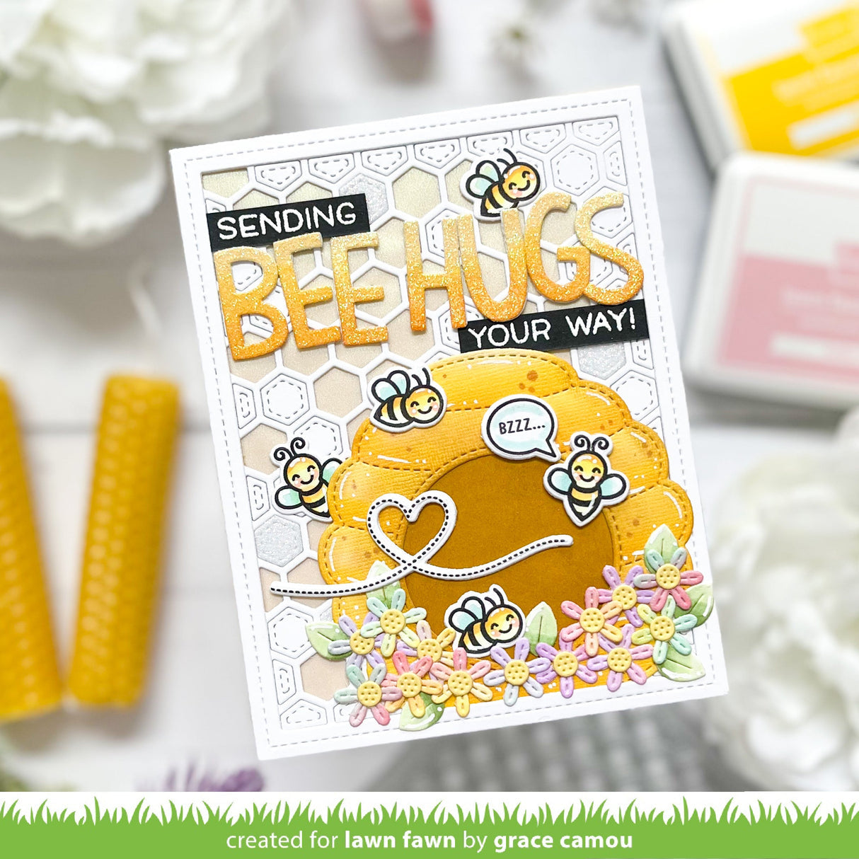 Card with 'Sending Bee Hugs Your Way' text and bee-themed design on a blurred background