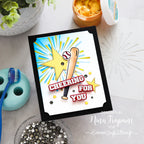 Card with a baseball bat and star design on a table with stationery items.
