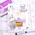 Card with a bunny and cupcake design, featuring the text 'Sweet moments are meant to be shared', with Gina K. Designs stamp and ink pad in the background.