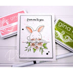 Card with a bunny and flowers design, surrounded by Gina K. products on a white background with from me to you sentiment