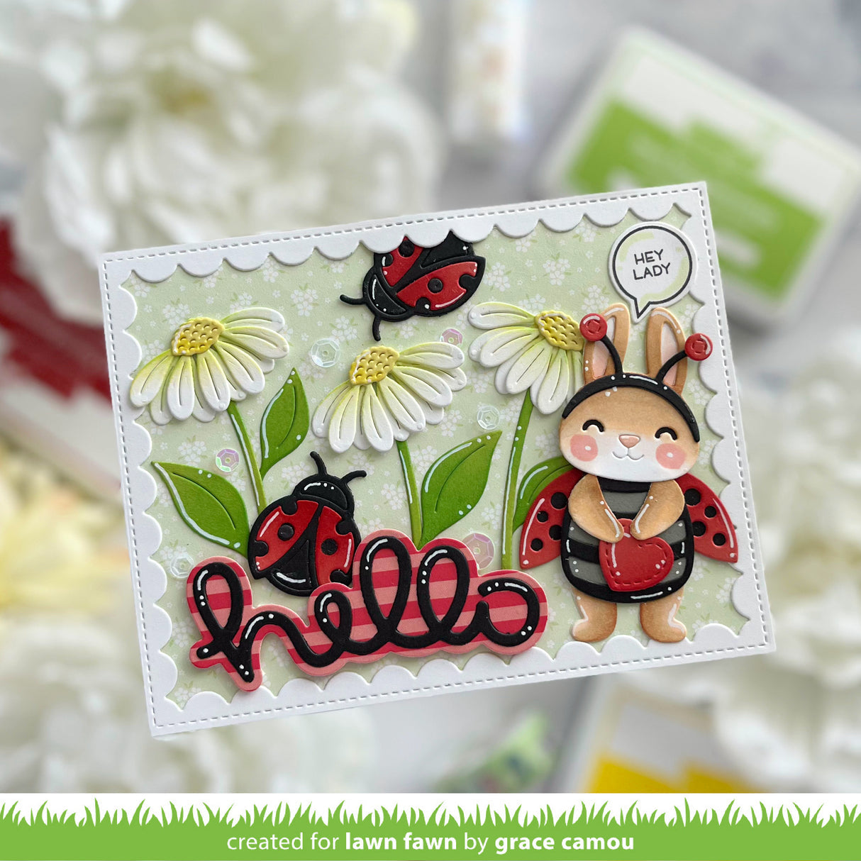 Card with a cute illustration of a bunny in a ladybug costume and ladybugs among flowers, with 'hello' text.