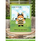 Card with a fox bee design and text on a wooden surface