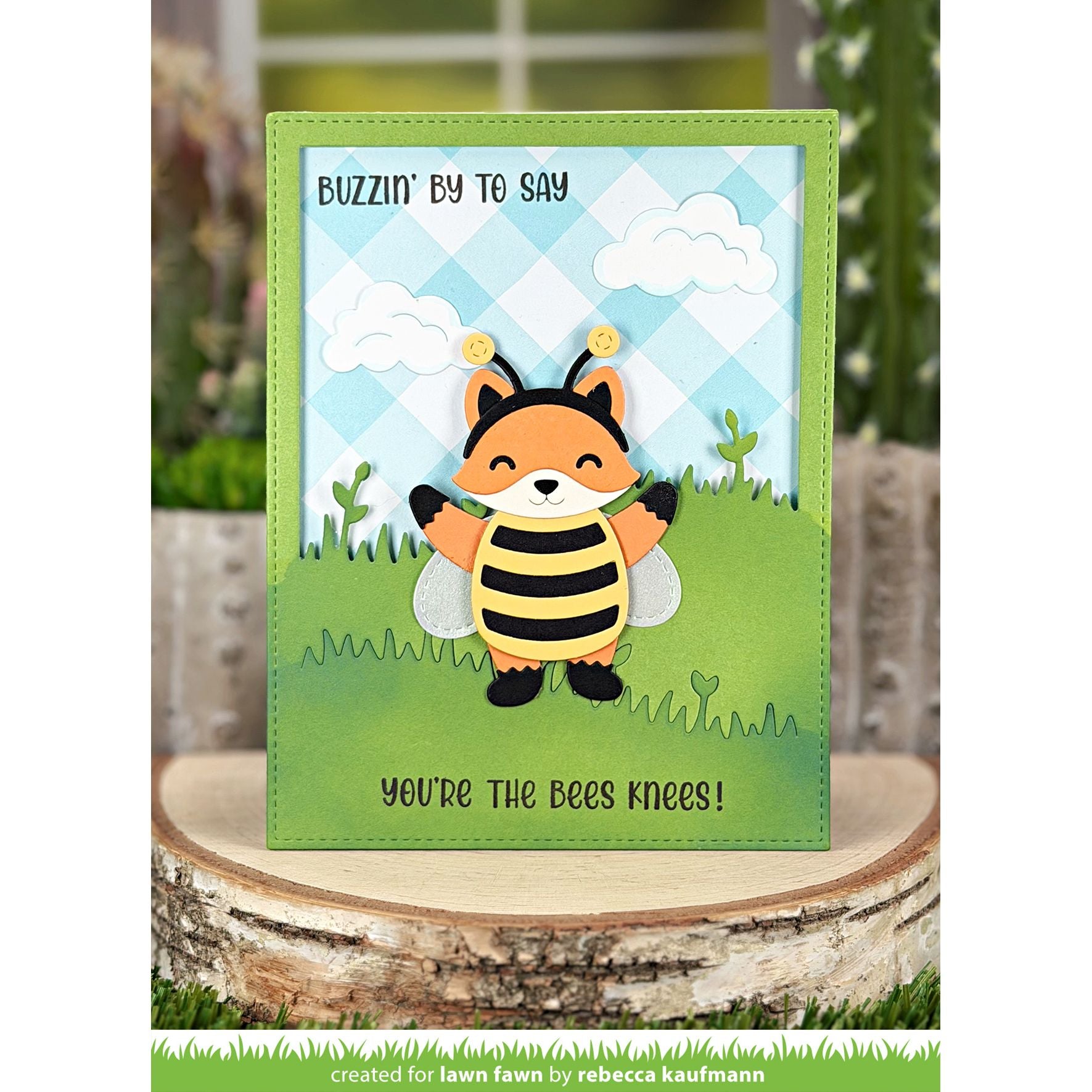 Card with a fox bee design and text on a wooden surface
