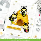Card with bee-themed design and 'You're Bee-utiful!' text, surrounded by crafting tools.