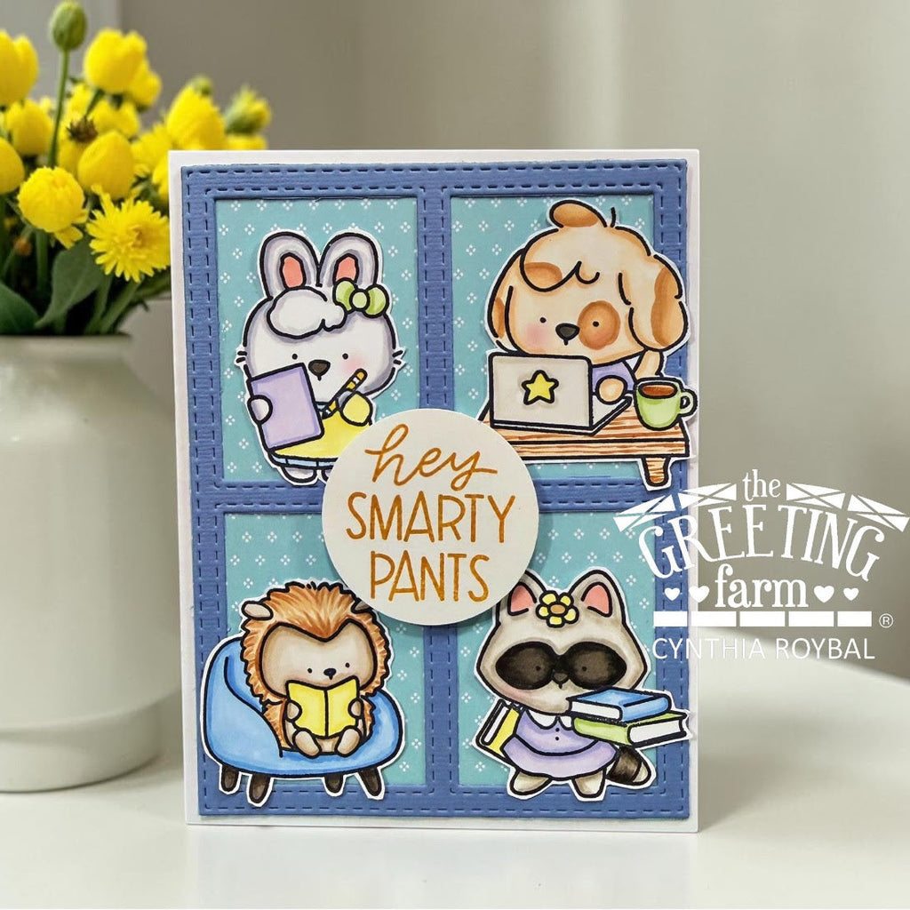 Card with cartoon animals and text 'Hey Smarty Pants' by The Greeting Farm, next to a vase of yellow tulips.
