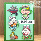 Card with cartoon bunnies planting flowers and vegetables, featuring 'The Greeting Farm' branding.