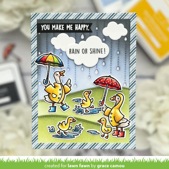 Card with cartoon ducks holding umbrellas and text 'You make me happy. Rain or shine!' on a blurred background.