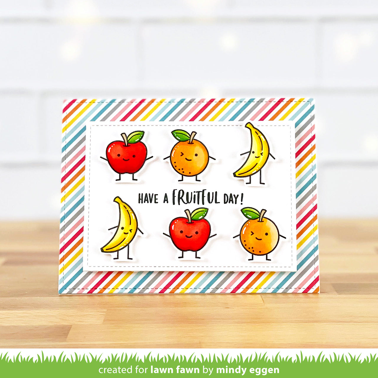 Card with cartoon fruits and 'Have a Fruity Day!' text on a striped background