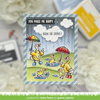 Card with ducks holding umbrellas and text 'You make me happy, rain or shine!' on a blurred background.