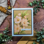 Card with floral design and 'Hello friend' text on a decorative background with greenery and stationery.
