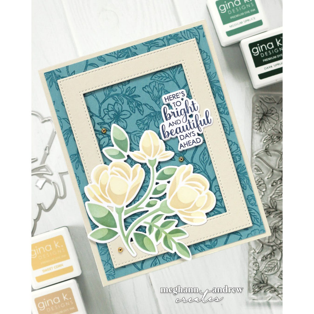 Card with floral design and text 'Here's to bright and beautiful days ahead' surrounded by stamping supplies.