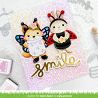 Card with fox and rabbit characters wearing insect costumes, surrounded by floral designs and the word 'smile'.