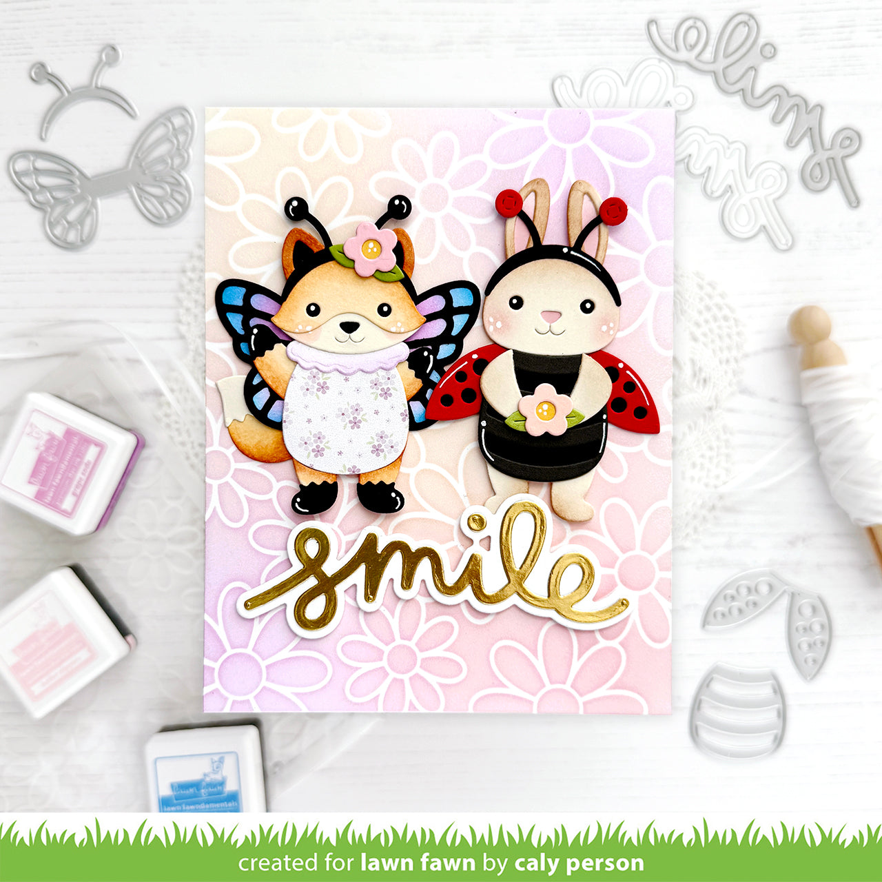 Card with fox and rabbit characters wearing insect costumes, with 'smile' sentiment