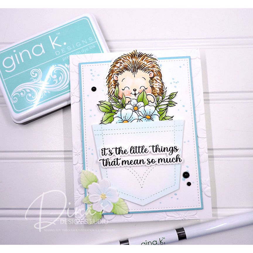 Card with hedgehog design and floral elements, featuring 'gina k' branding including the sentiment 'it's the little things that mean so much'