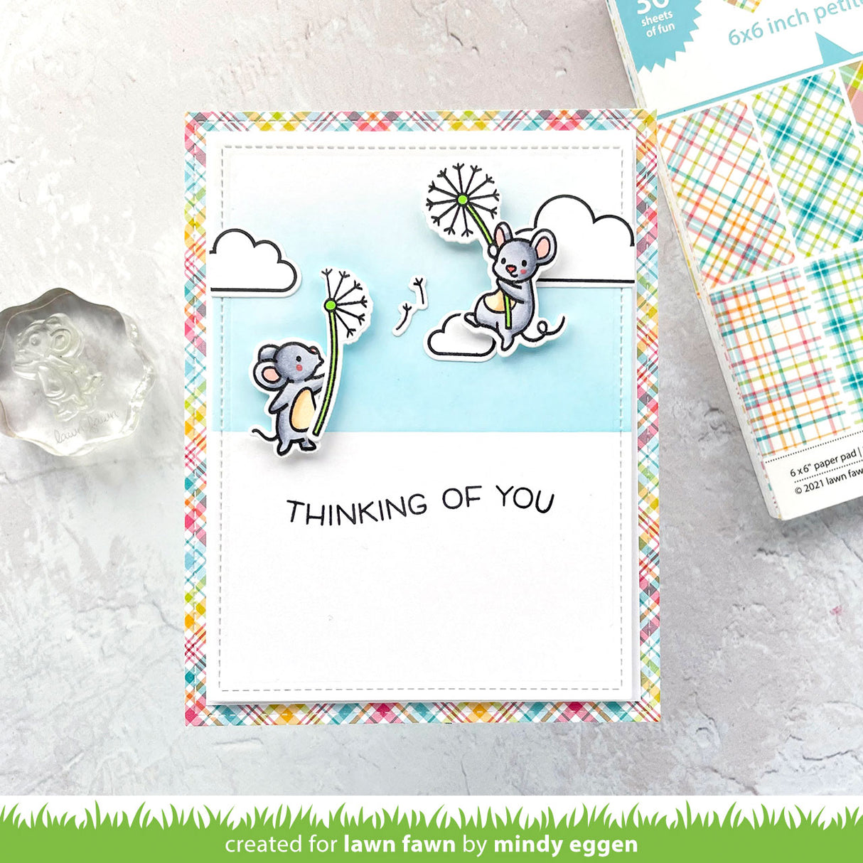 Card with mice and 'Thinking of You' text on a colorful border, with additional stationery items in the background.