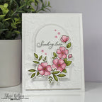 Card with pink flowers and 'Sending love' text on a textured white background