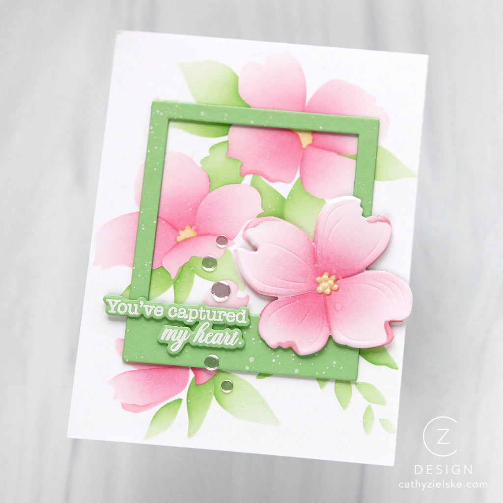 Card with pink flowers and green frame on a white background with sentiment 'you've captured my heart'