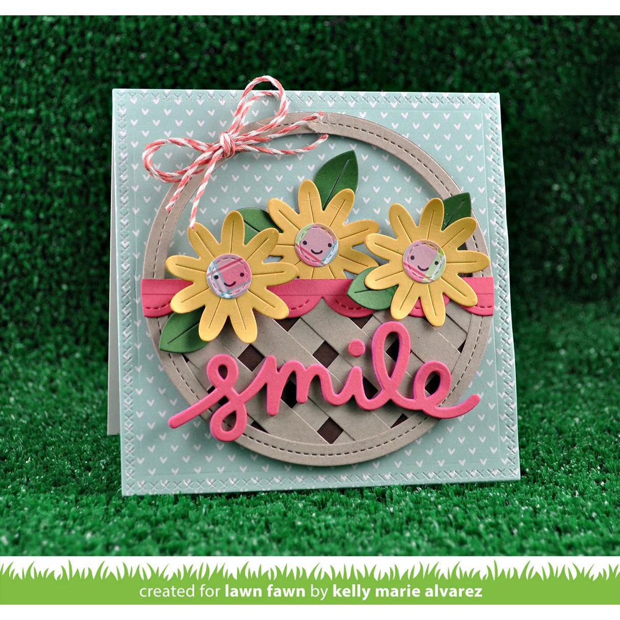 Card with sunflower design and 'smile' text on a green grass background