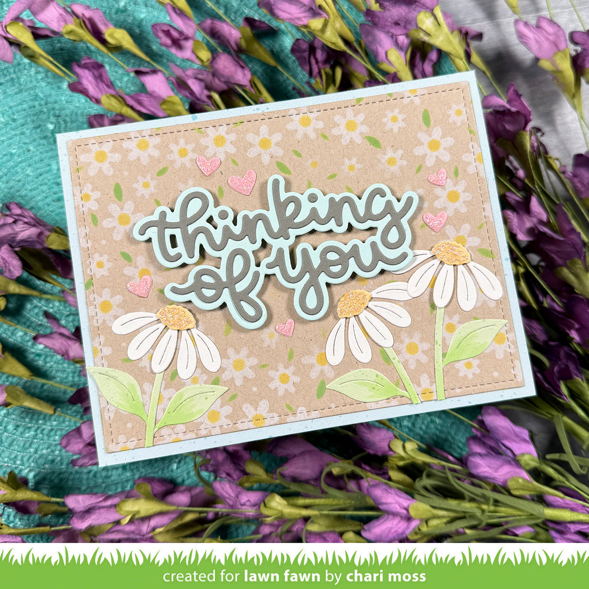 Card with 'thinking of you' text and floral design on a floral background