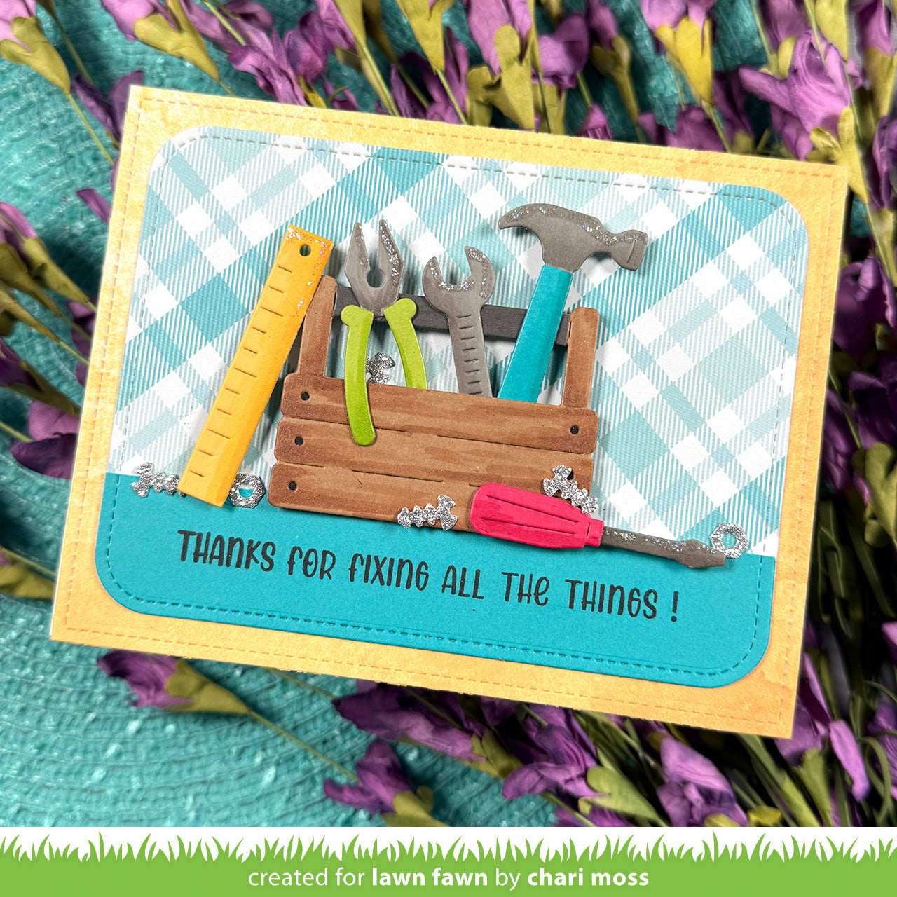 Card with tools and text 'Thanks for fixing all the things!' on a checkered background, surrounded by flowers.