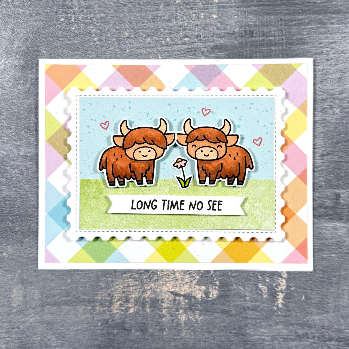 Card with two highland cows and 'Long Time No See' text on a colorful geometric patterned background.