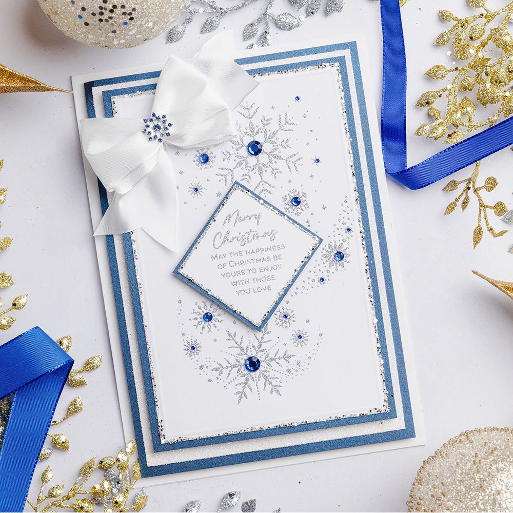 Chloe's Creative Cards Snowflake Trails Clear Stamp Set c-stam-snowt blue and white trim white bow blue sequins christmas card
