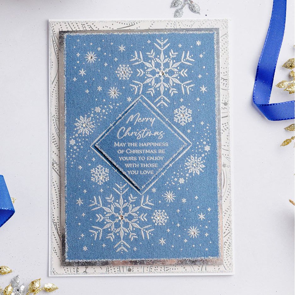 Chloe's Creative Cards Snowflake Trails Clear Stamp Set c-stam-snowt blue background white snowflakes and stars christmas card