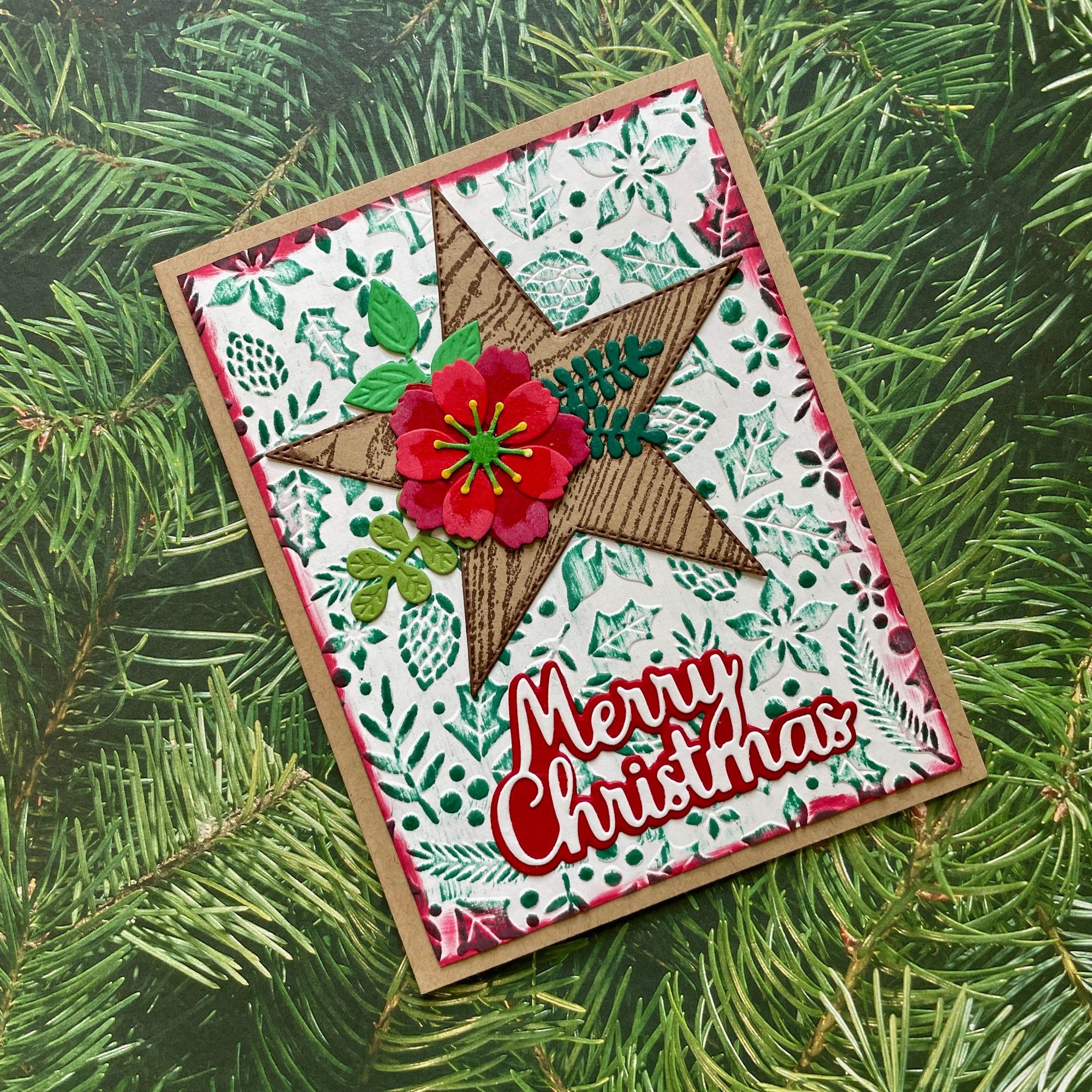 Christmas card with star design and 'Merry Christmas' text on a green leaf background