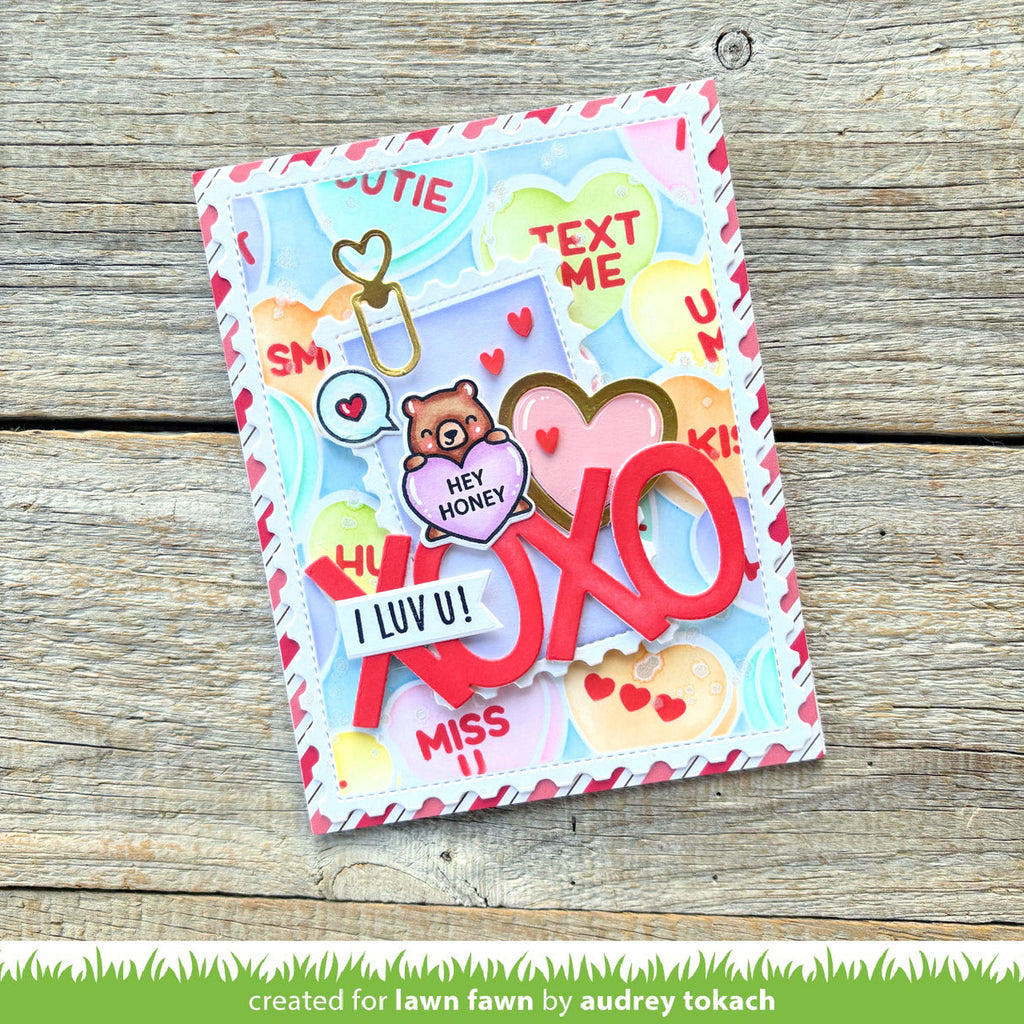 Colorful card with love-themed text and graphics on a wooden surface
