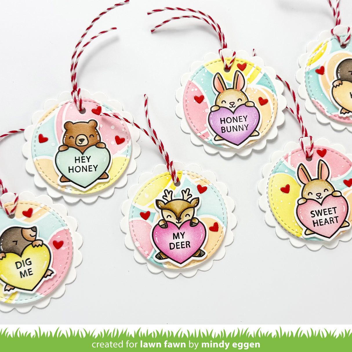 Decorative tags with animal illustrations and heart-shaped messages on a white background.