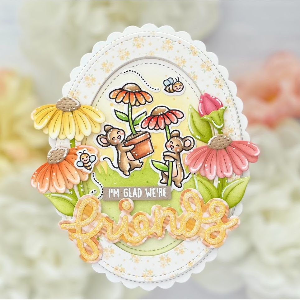 Decorative card with cartoon mice, flowers, and the text 'I'm glad we're friends' on a blurred floral background.