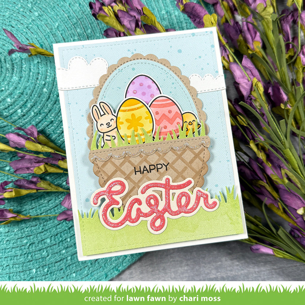 Easter card with colorful eggs and a bunny and chick in a basket, surrounded by flowers.