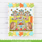Colorful card with hedgehogs, trees, and autumn elements on a wooden background